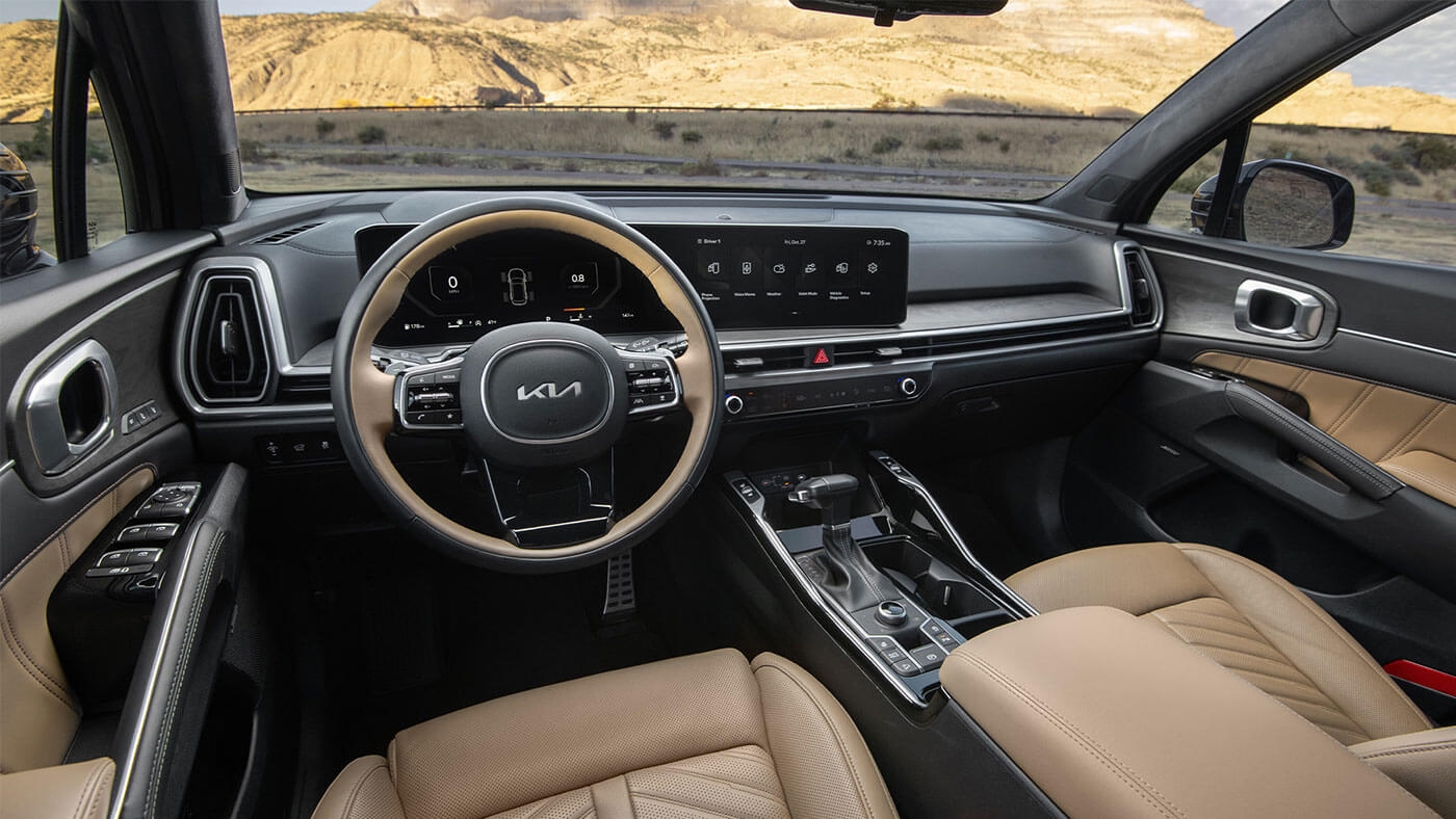 Vue 3/4 arrière du Kia Sorento hybride 2025 roulant sur une route.